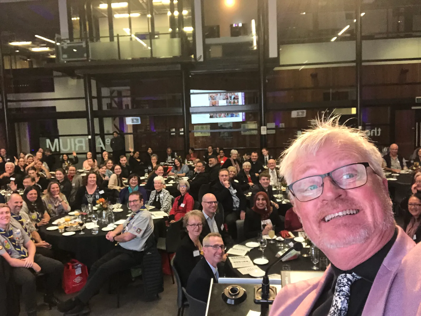 Mark taking a selfie with a huge audience behind him